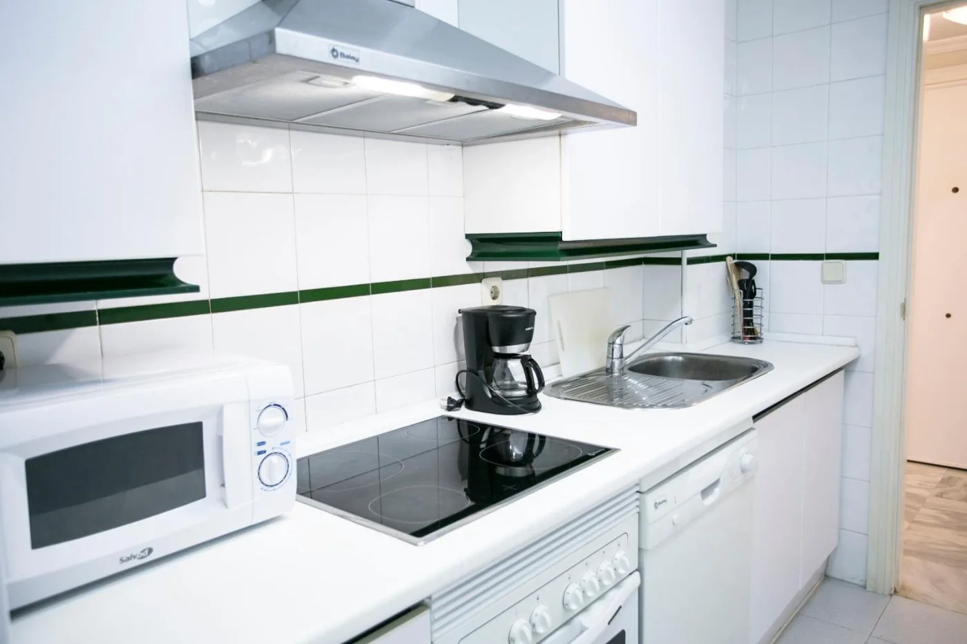 Cocina equipada con vitrocerámica y microondas